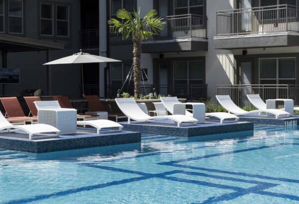 Griffis Oak Lawn apartment community resort style pool with lounge chairs in Dallas, TX.