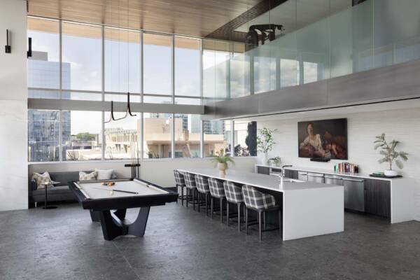 Apartment community resident lounge with pool table and kitchen at Griffis Platform Union Station in Denver, CO