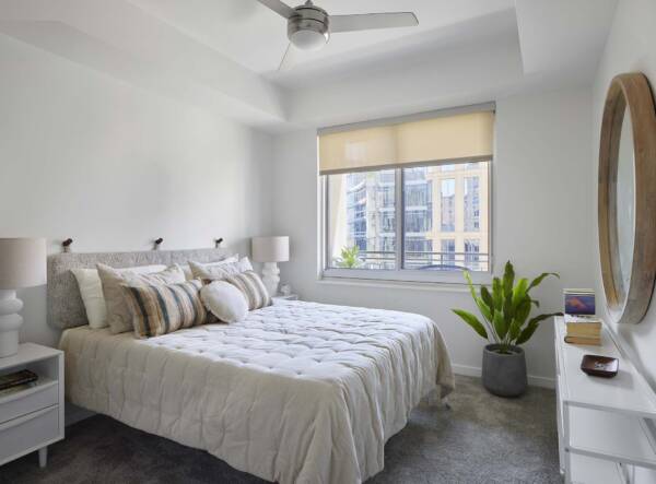 Spacious apartment bedroom with carpet.