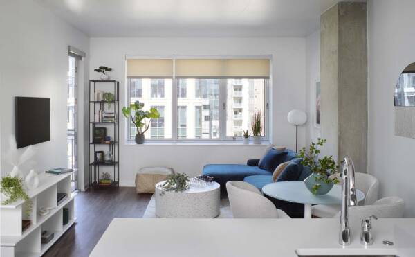 Apartment living room with wood style floor and balcony door.