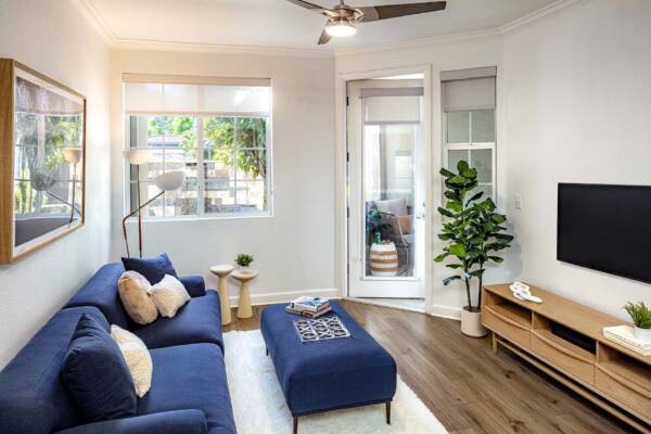 Griffis South Bay apartment living room with wood style floor and balcony door.